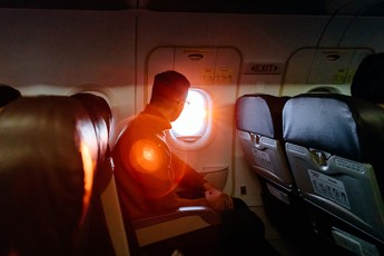 Man Looking Out of the Plane Window
